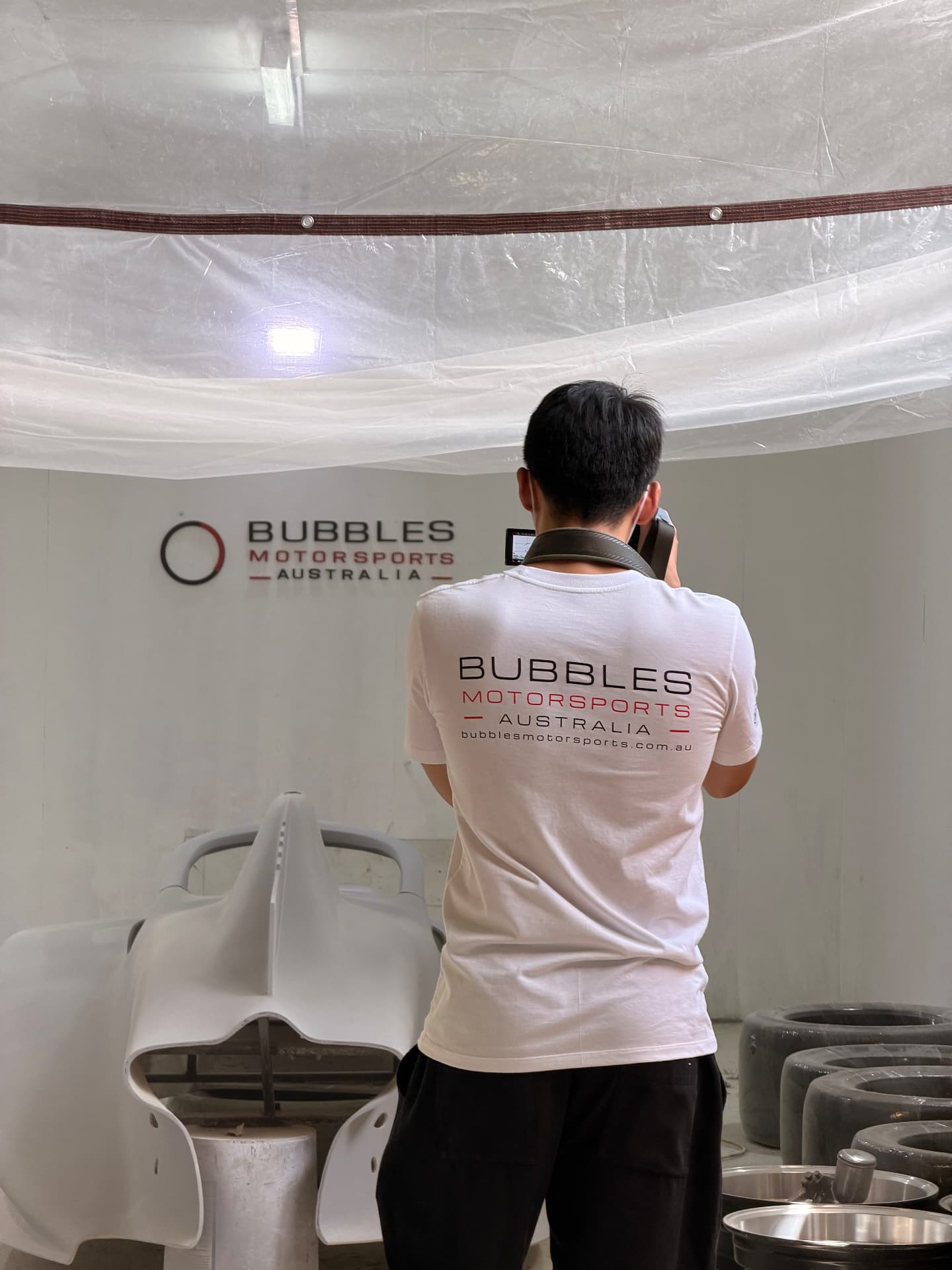 Bubbles Motorsports workshop team preparing a full-scale display car body